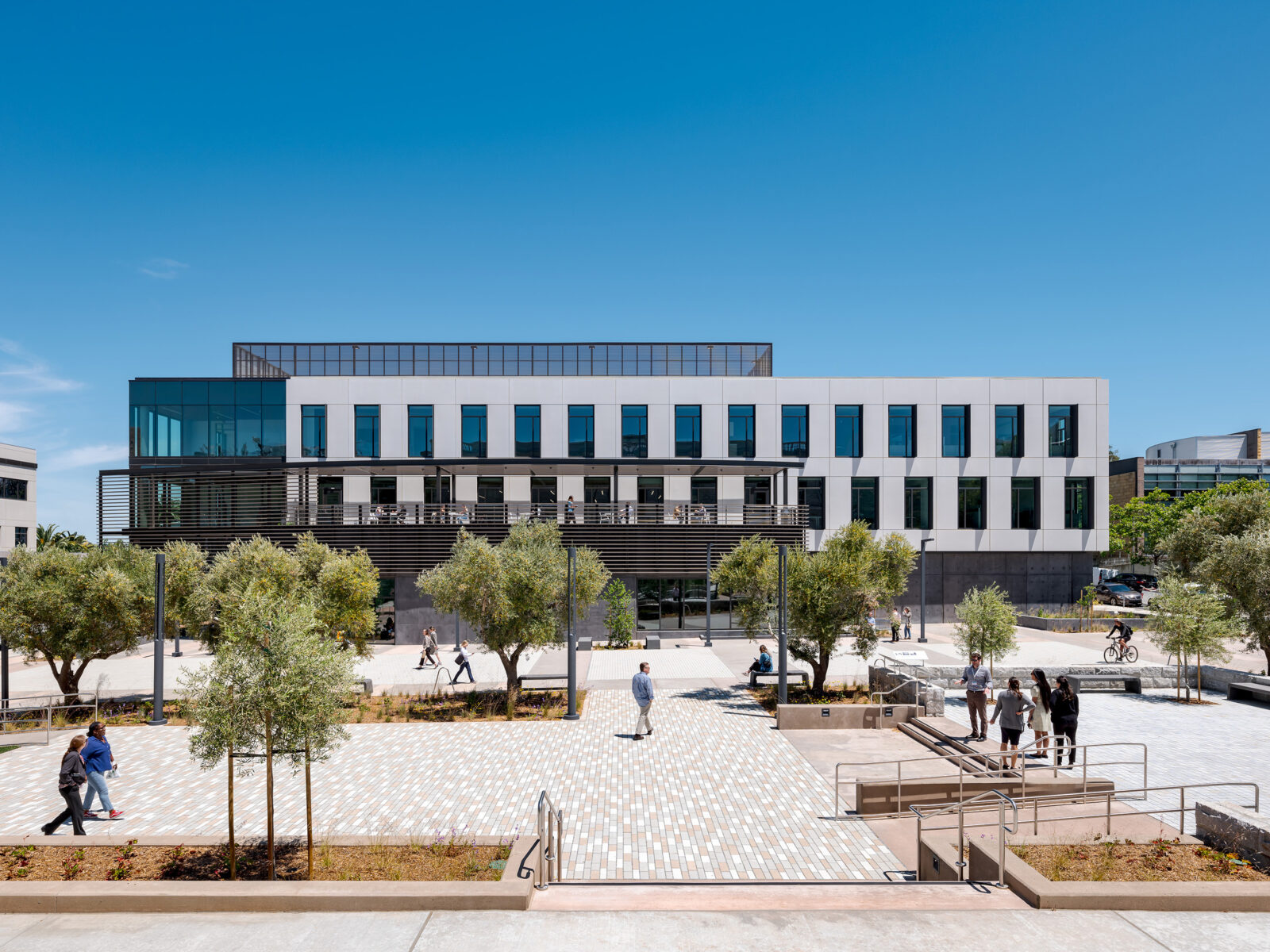 The new three-story admin building and the wide public plaza