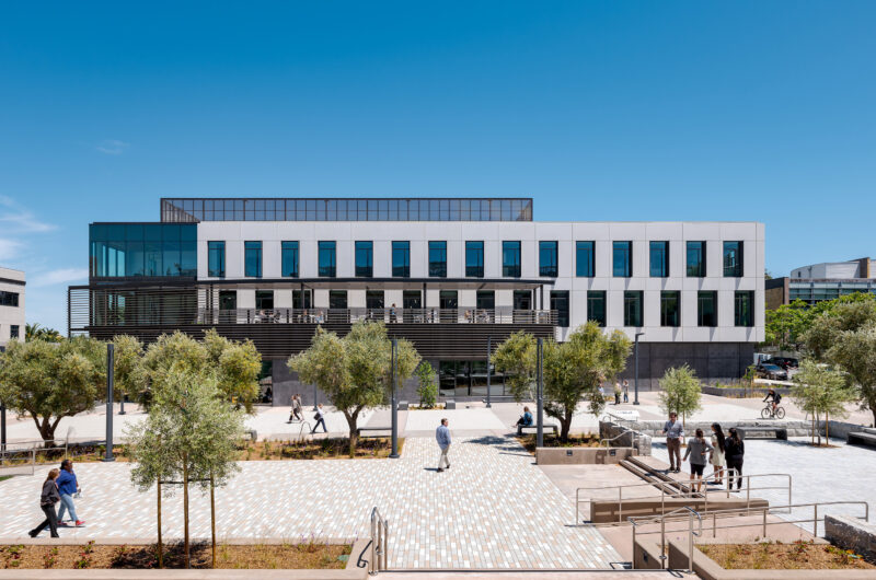 The new three-story admin building and the wide public plaza